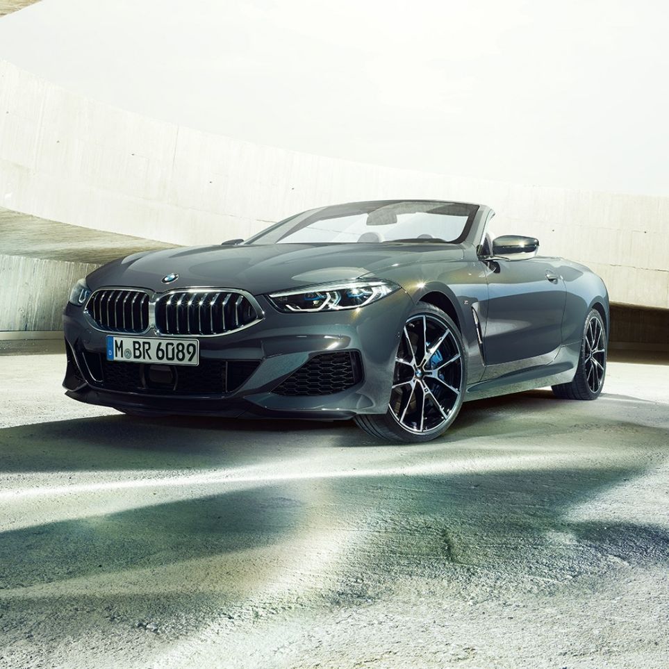 BMW M850i xDrive Cabrio, vista de tres cuartos del frontal. BMW M850i xDrive Cabrio en Dravitgrau metalizado con la capota abierta, vista de tres cuartos del coche deportivo descapotable