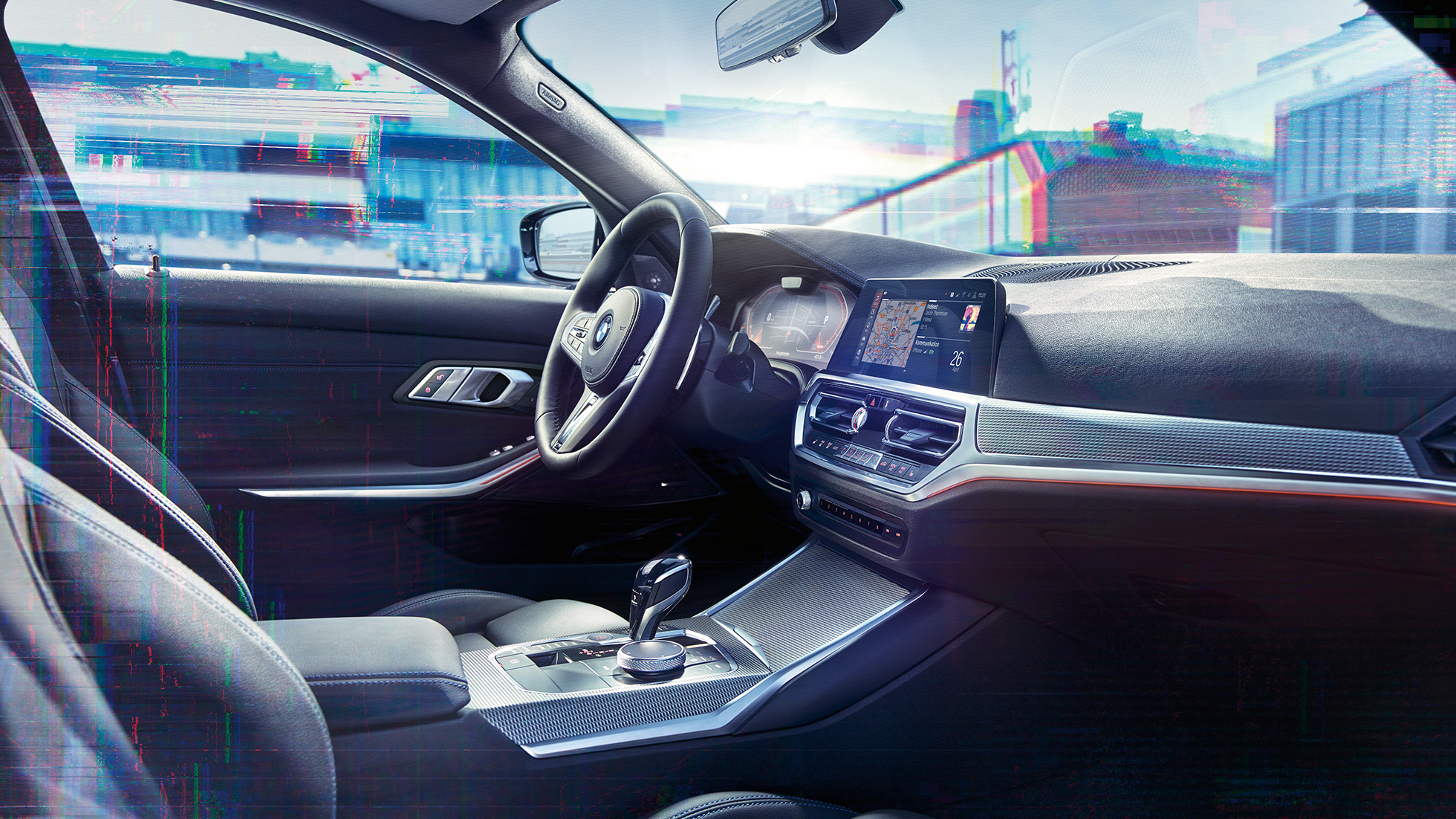 BMW Serie 3, cuadro de instrumentos M Detalle del interior del BMW Serie 3 con una vista lateral del puesto de conducción y un cuadro de instrumentos con pantalla M.