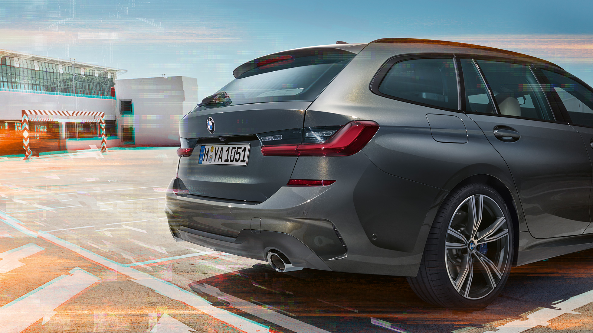BMW 3 Series Touring, three-quarter rear view on parking lot BMW 3 Series Touring, three-quarter rear view on parking lot in urban environment