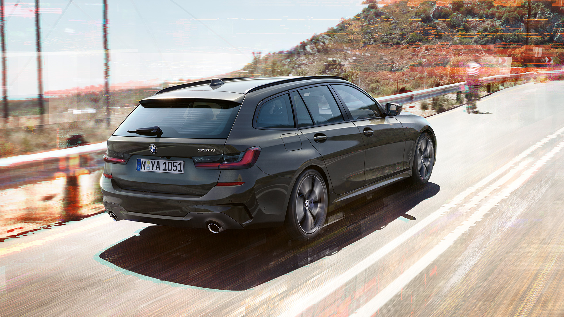 BMW 3 Series Touring, three-quarter rear shot BMW 3 Series Touring, three-quarter rear shot driving on bridge in front of rural surroundings