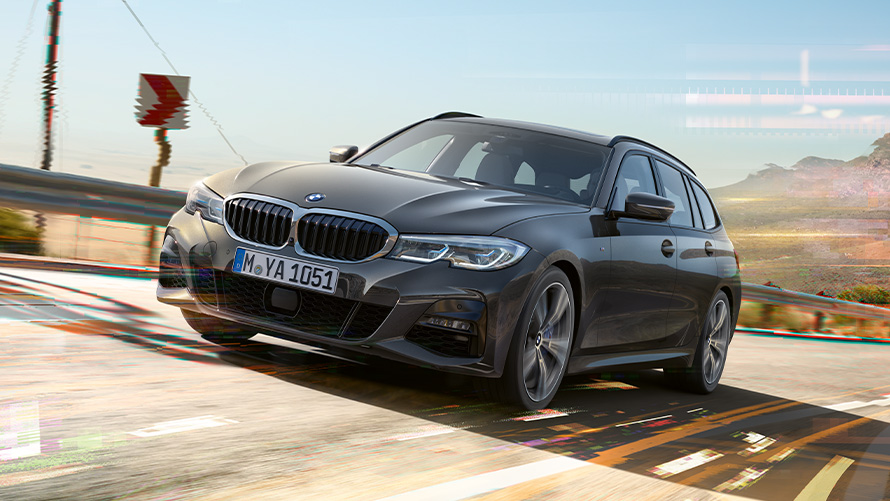 BMW Serie 3 Touring (G21), Dravit Grey, toma de tres cuartos del frontal BMW Serie 3 Touring (G21) Dravit Grey, toma de tres cuartos del frontal en un entorno rural