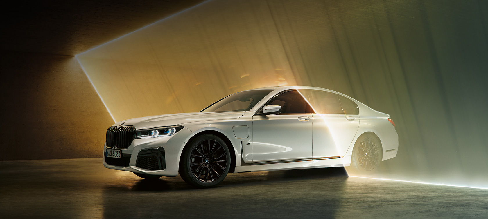 BMW Serie 7, blanco, en vista de tres cuartos del frontal BMW Serie 7: BMW blanco en vista de tres cuartos del frontal rodeado de luces