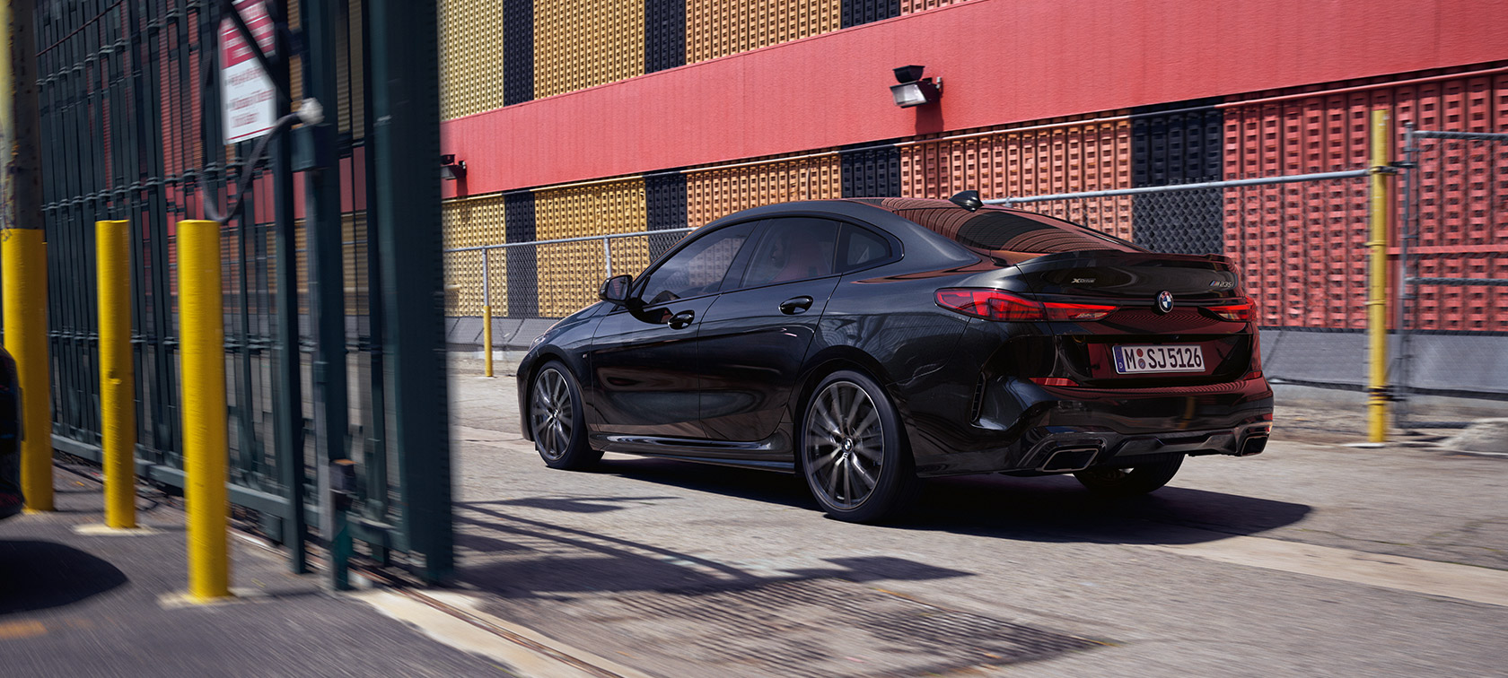 BMW M235i xDrive Gran Coupé F44 vista de tres cuartos de la zaga, en marcha BMW M235i xDrive Gran Coupé F44 Black Sapphire metalizado, vista de tres cuartos de la zaga, en marcha