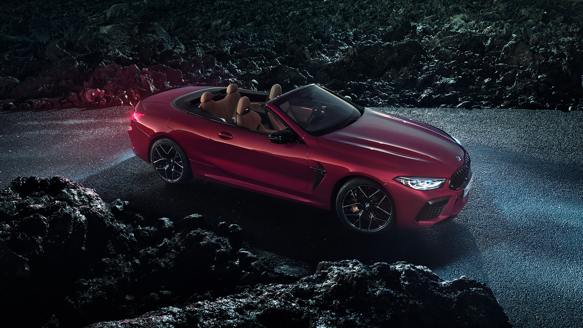 BMW M8 Competition Cabrio, vista de tres cuartos del lateral F91. BMW M8 Competition Cabrio color en Motegi Rot parado sobre el asfalto de noche F91.